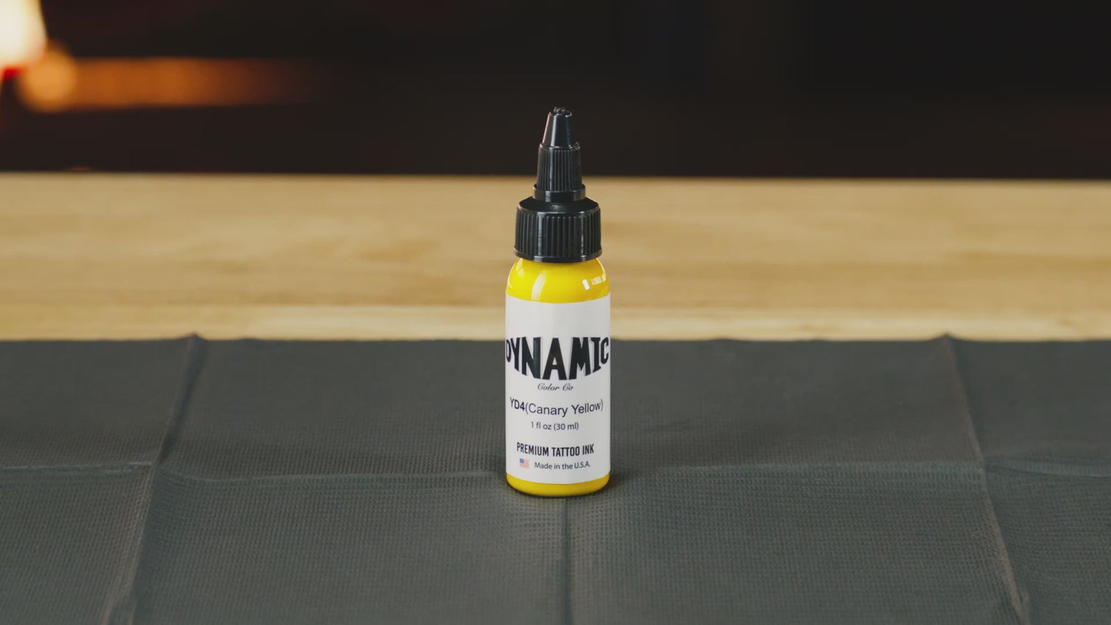 Dynamic Canary Yellow tattoo ink bottle on a countertop