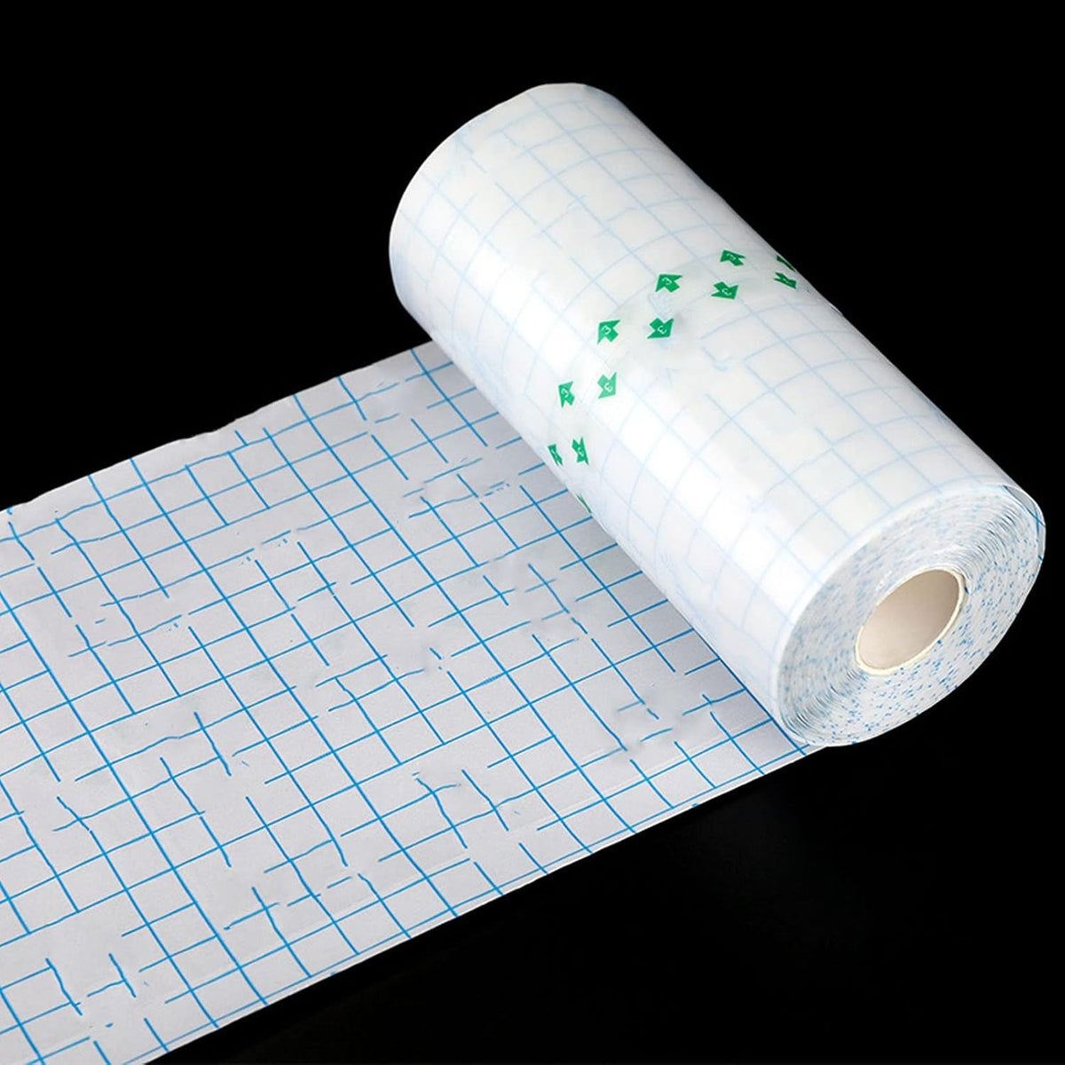 Transparent tattoo protective film roll with a partially unrolled grid-backed sheet