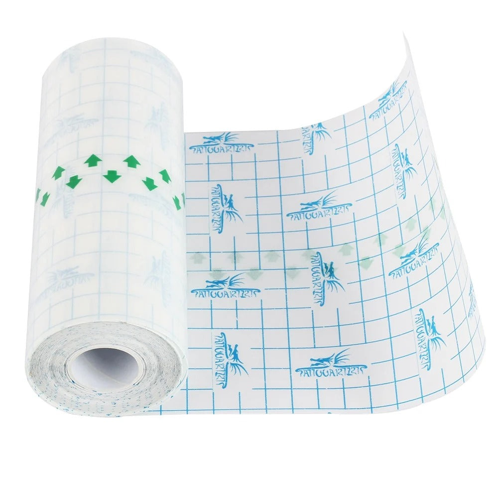 Tattoo protective film roll with grid backing unrolled on a white background