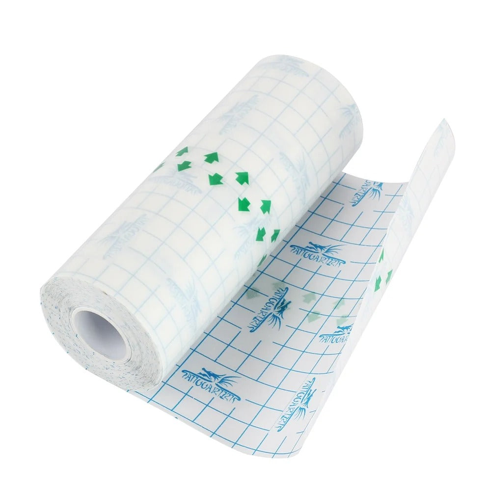 Angled tattoo protective film roll with a loose sheet of grid backing