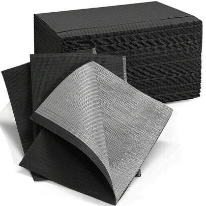 Stack of black disposable dental bibs with one bib folded forward